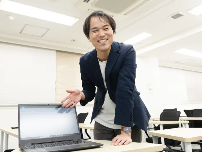 個別面談でノートパソコンを指しながら生活習慣やキャリアプランについて説明する生活支援員