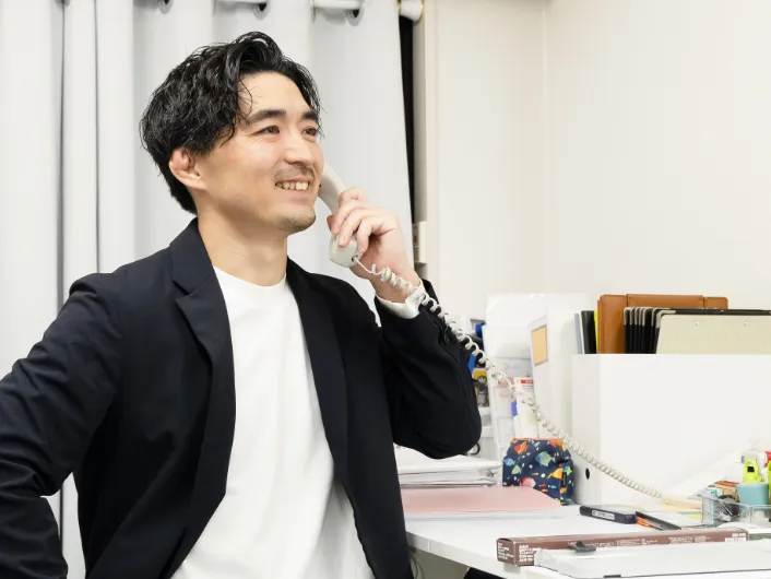 デスクで電話応対をしている様子